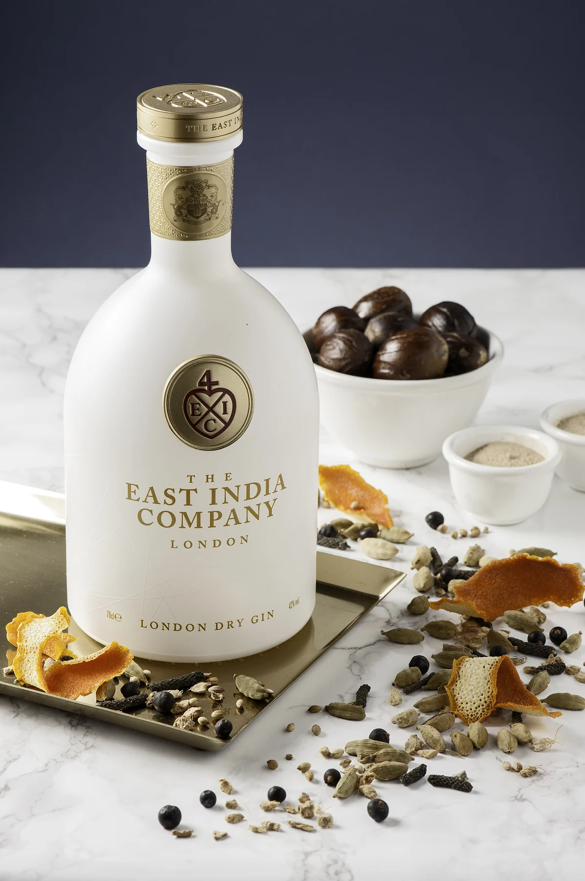 The East India Company London Dry Gin with orange peel, nutmeg and botanicals on marble